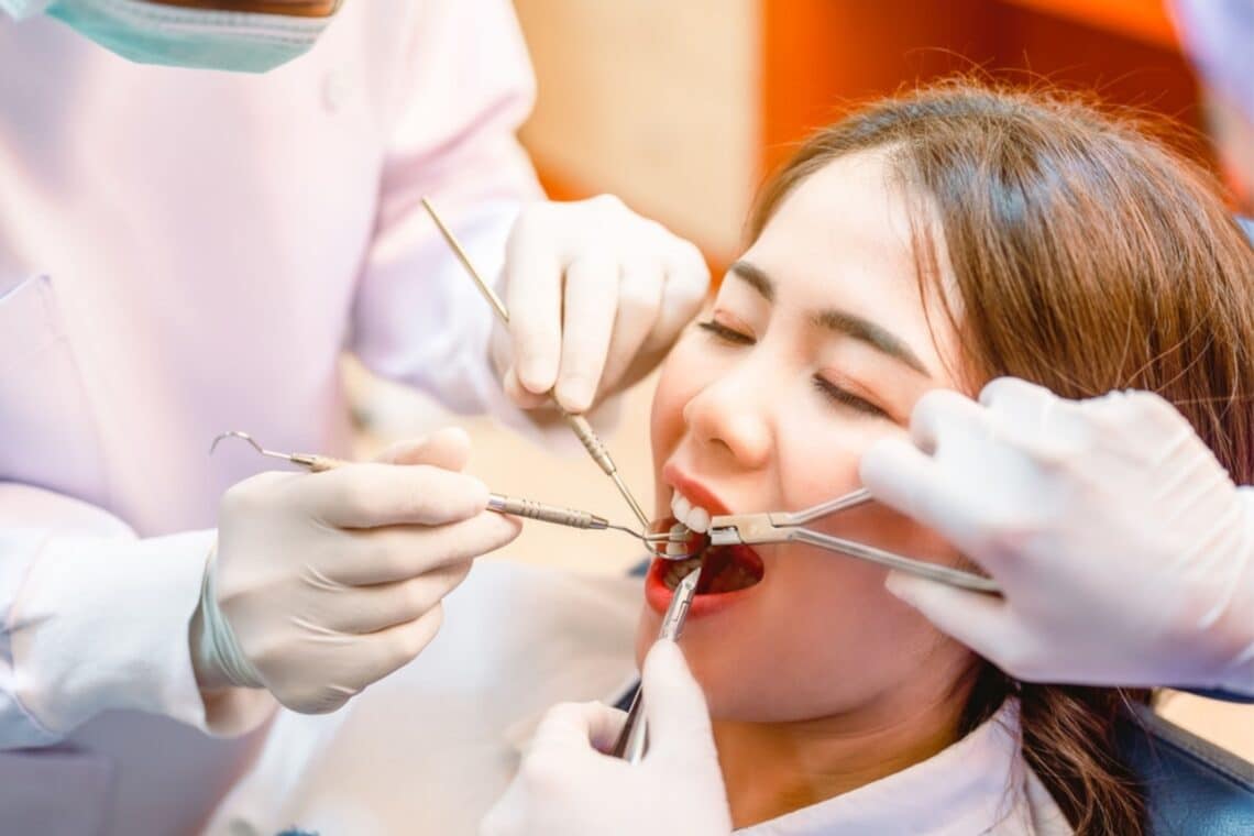 Oral surgeon in Sulphur Springs, TX examining patient for wisdom teeth removal symptoms