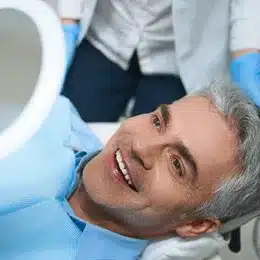 Patient smiling in dental chair during examination at Summit Dental Sulphur Springs office.